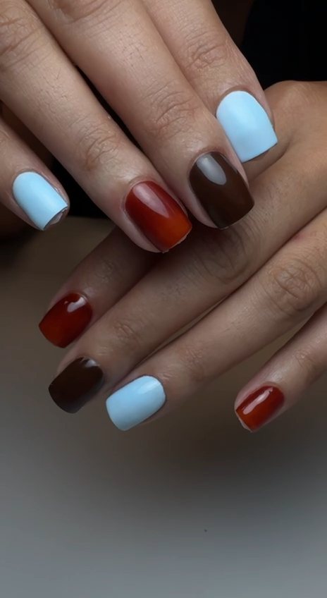 Short square gel manicure in sky blue, chocolate brown and burnt orange at Paradisse Studio, Richmond Hill