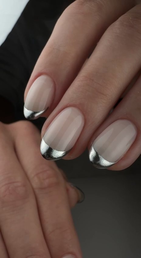Sheer nude oval gel nails with silver chrome French tips at Paradisse Studio, Richmond Hill