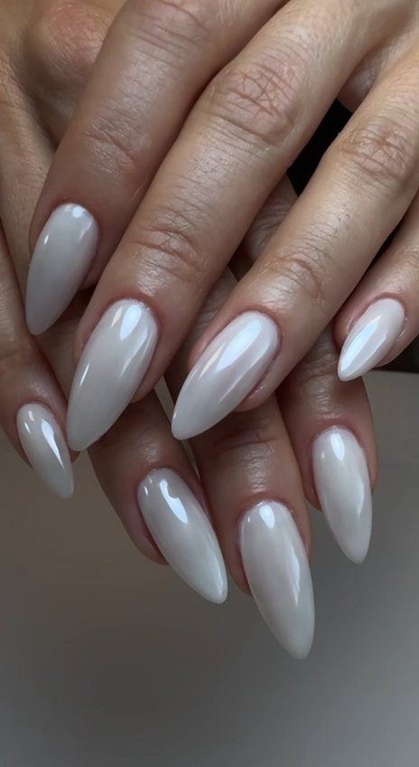 Long almond gel nails in a glossy milky white at Paradisse Studio, Richmond Hill