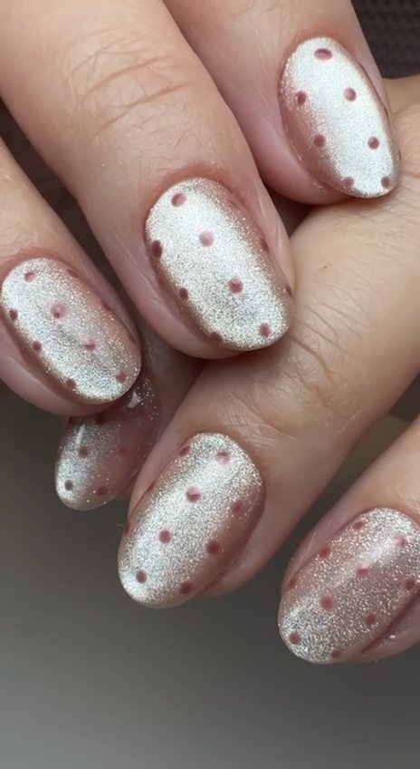 Round nails in champagne cat-eye shimmer gel with hand-placed rose polka dots at Paradisse Studio, Richmond Hill